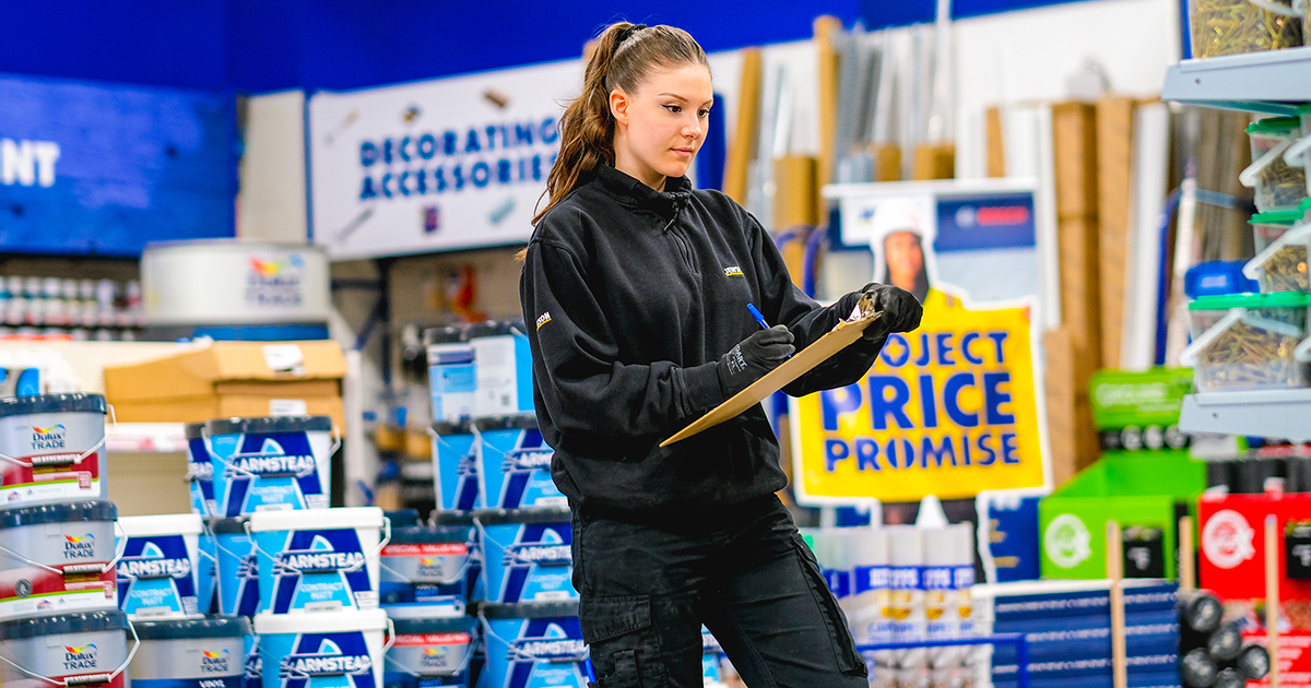 Young woman holding a clipboard in a builders merchant